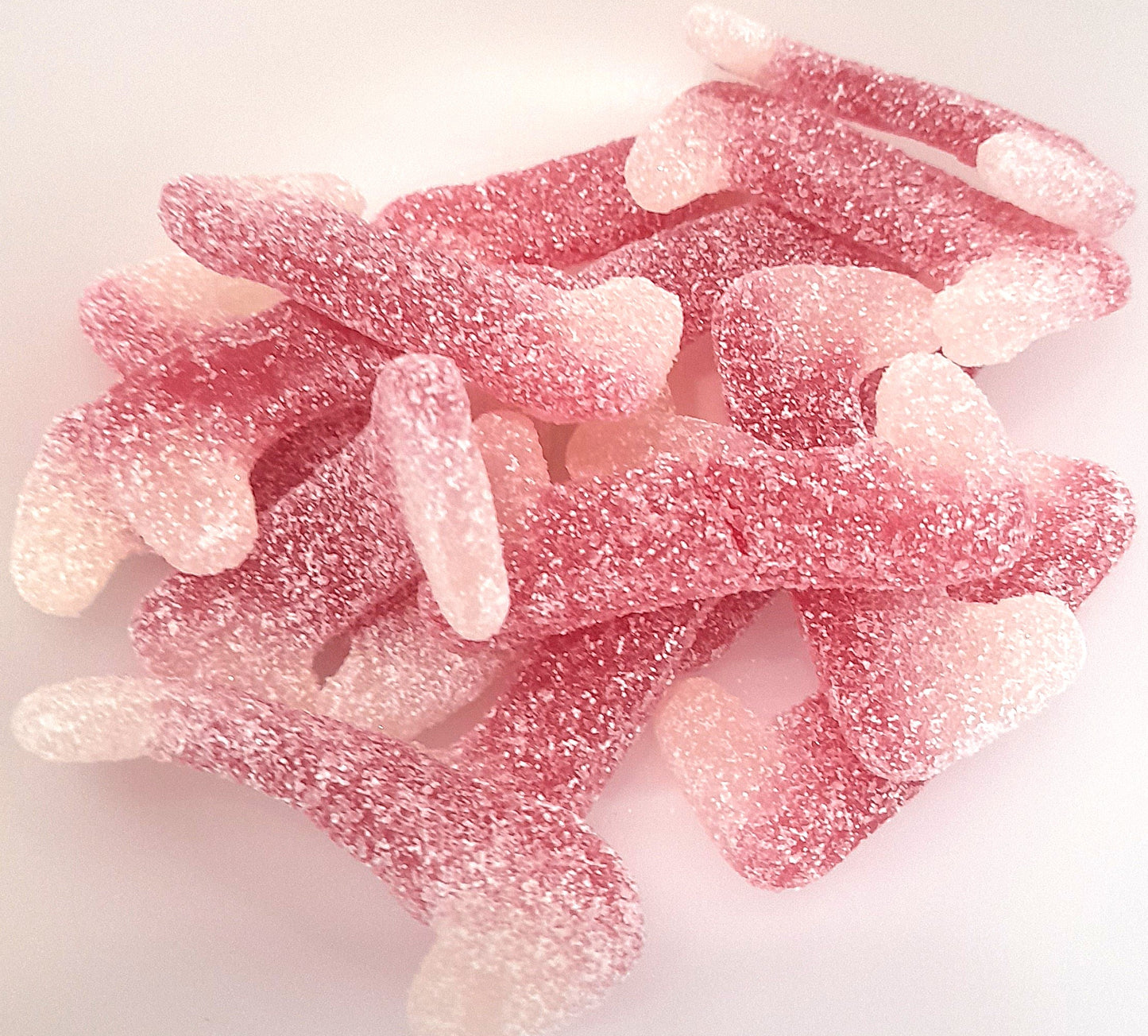 A bowl of pink, fizzy Dracula teeth sweets.