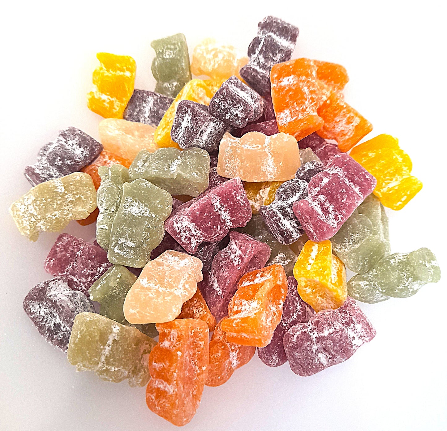 A variety of colorful jelly babies in different shapes and flavors, with a mix of orange, pink, green, and yellow colors.