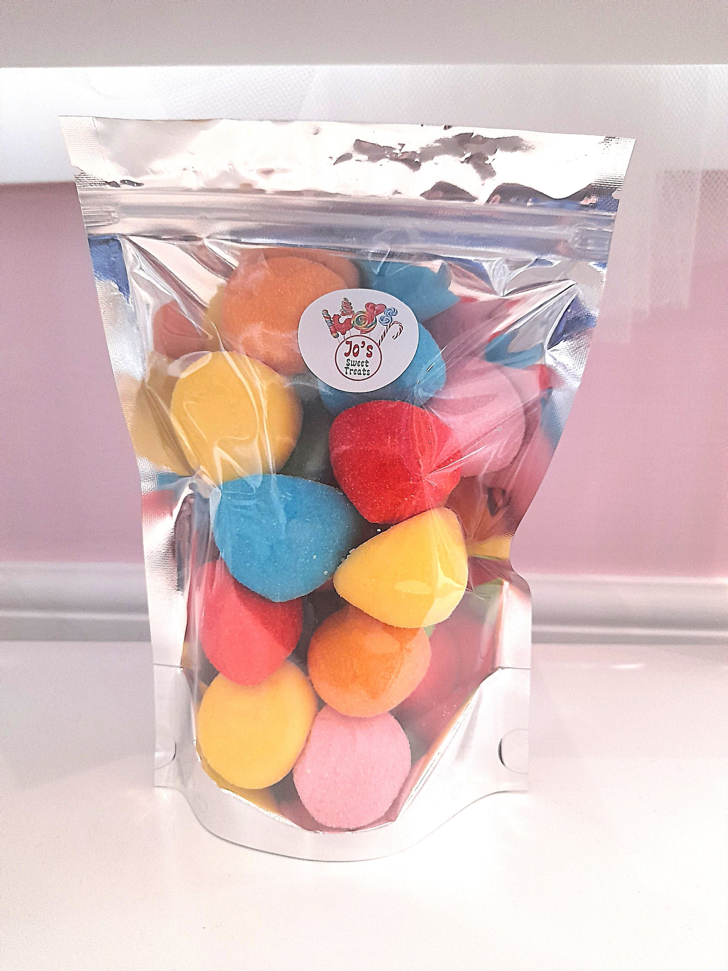 A clear plastic packaging containing multicolored sugar coated marshmallows.