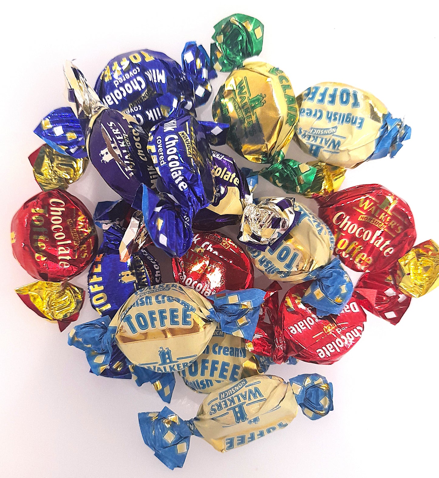 An assortment of toffee and chocolate eclairs, individually wrapped, with various flavors such as chocolate toffees, milk and dark chocolate covered toffees, and banana split, all visible in a scattered arrangement.