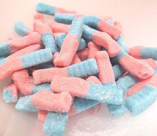 A close-up of Fizzy Bubblegum Bottles candy, with the individual pieces having a pink and blue color scheme.