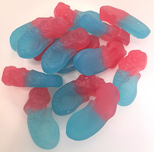 A group of bubblegum flavored gummy sweets shaped like mermaids, with a mix of pink and blue colors.