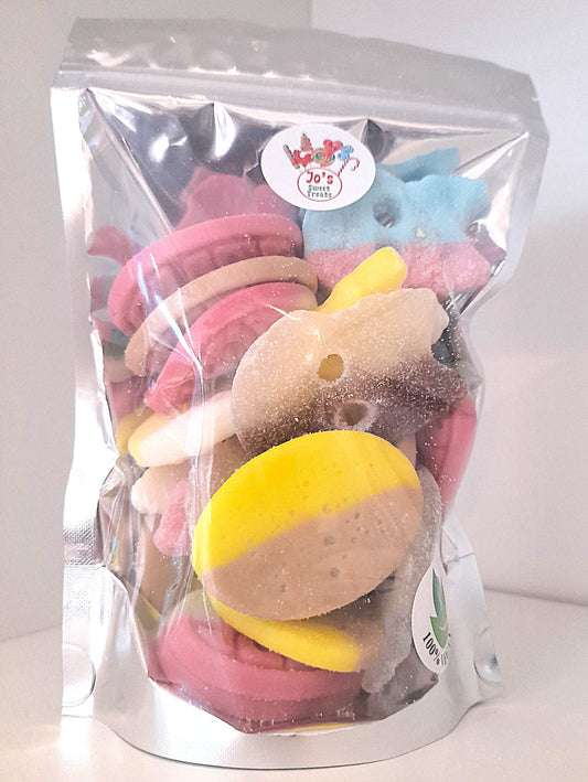 A clear plastic pouch filled with various candies and cookie pieces, labeled 'BUBS' and 'Vegan'.