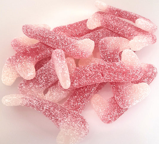 A bowl of pink, fizzy Dracula teeth sweets.
