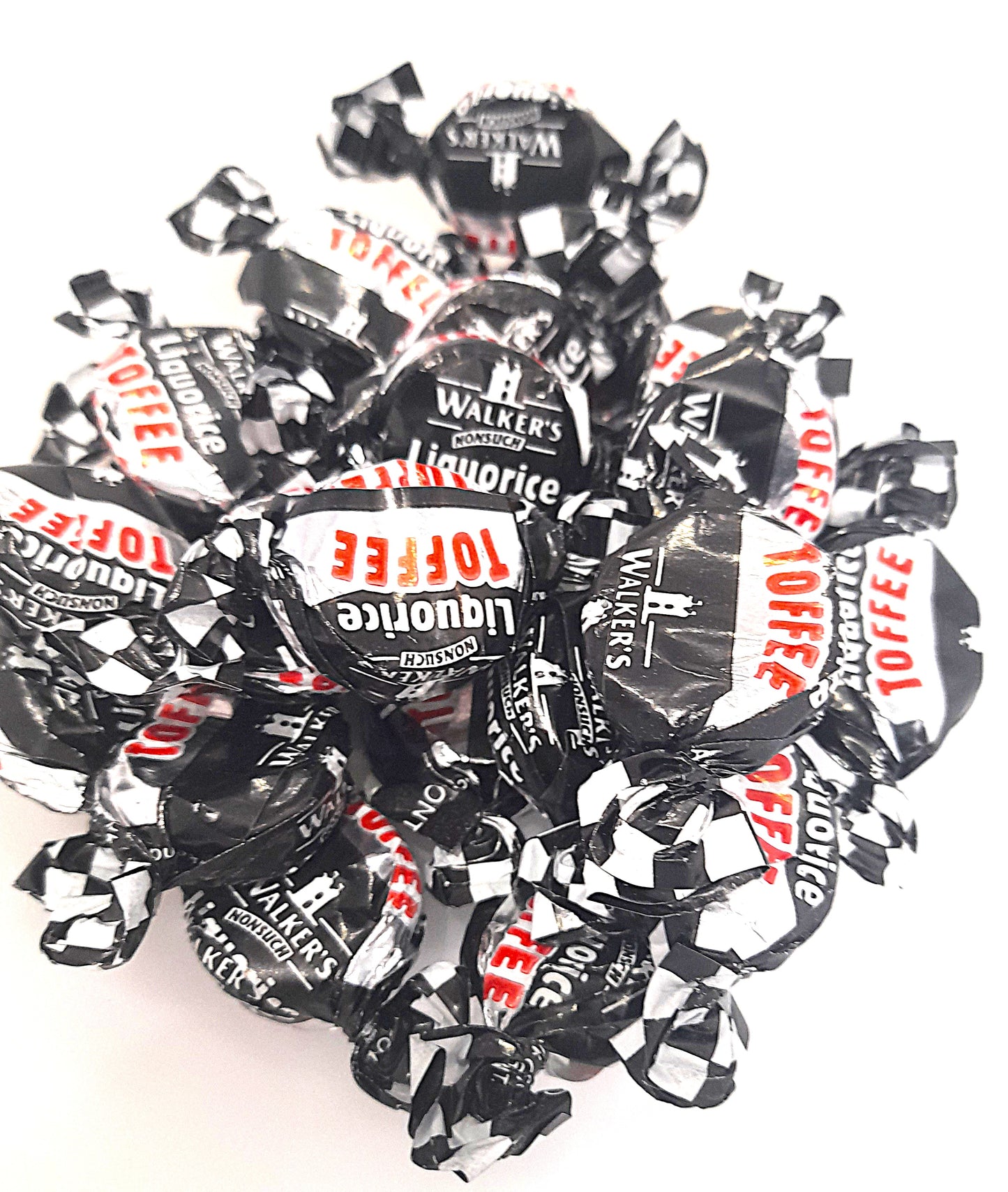 Individually wrapped black liquorice toffees with a checkered pattern on the wrappers, branded by Walkers Nonsuch.