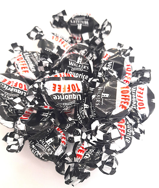 Individually wrapped black liquorice toffees with a checkered pattern on the wrappers, branded by Walkers Nonsuch.