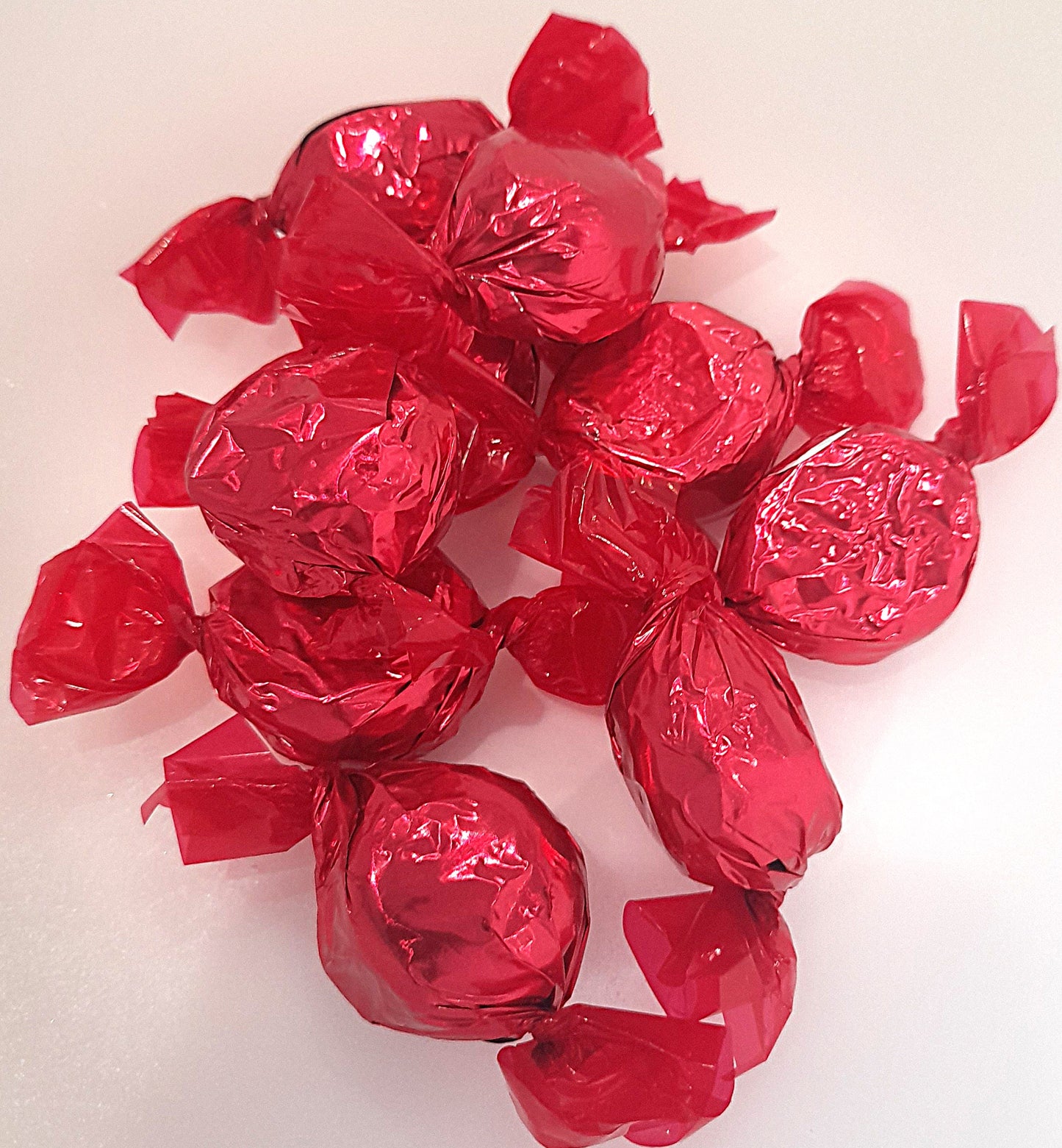 Individually wrapped raspberry-flavored coconut pieces in dark chocolate.