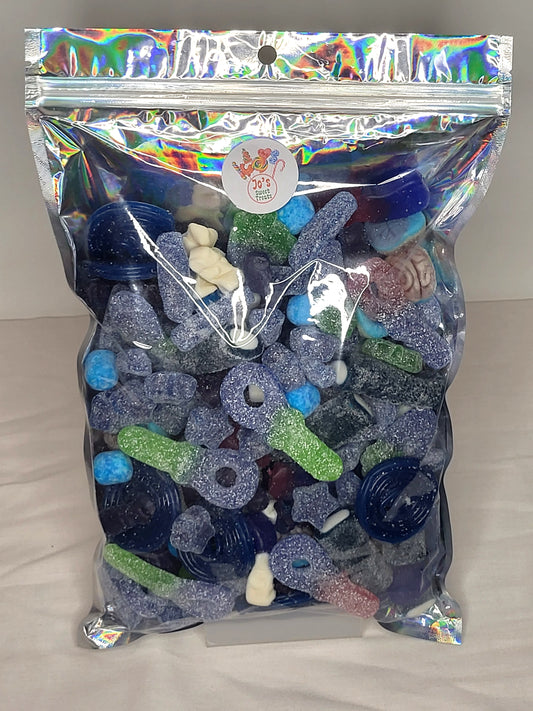 A resealable pouch containing a variety of blue sweets including fizzy tongue painters, blue raspberry wheels, and more.