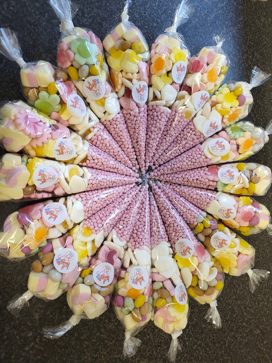 A selection of pick n mix sweets arranged in a flower shape with paper cones filled with various candies.